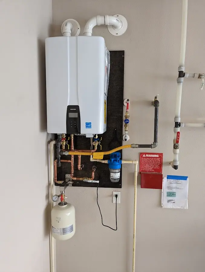 Professional plumber installing copper piping in a Fairport Harbor home